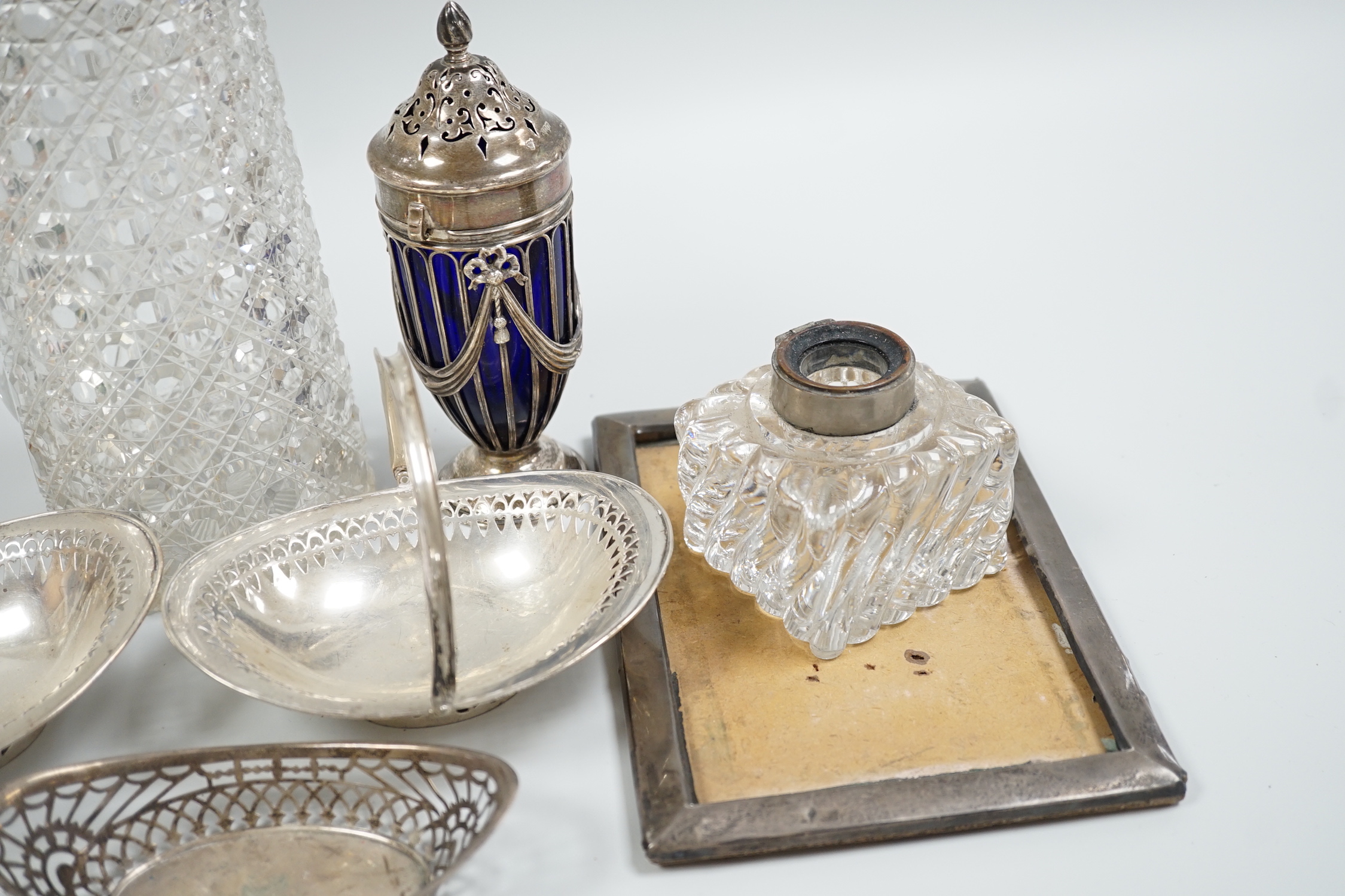 Sundry silver items including a Victorian silver mounted glass lemonade jug (a.f.), mounted glass sugar caster, damaged inkwell, photograph frame, pair of silver bonbon baskets and a small silver dish.